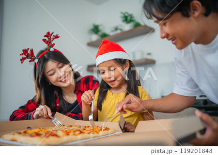 asian little family having christmas dinner together 119201848