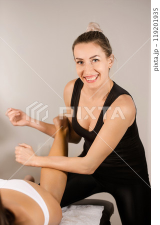 Portrait of a masseuse giving a Thai massage to a patient Portrait of a masseuse giving a Thai massage to a patient 119201935