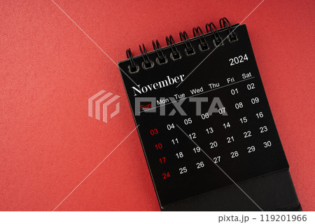 November black desk calendar for 2024 year on red cover background. 119201966