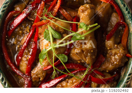Stew with chicken, vegetables, hot pepper and microgreens pea sprouts, close-up 119202492