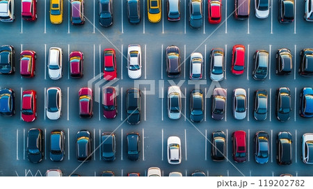 An aerial view of a crowded parking lot with cars neatly lined up, demonstrating patterns and organization in public parking areas 119202782