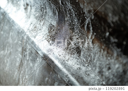 Close-up of a moldy surface inside an old metal pipe, showing corrosion and dirt accumulation. Close-up of a moldy surface inside an old metal pipe, showing corrosion and dirt accumulation. 119202891