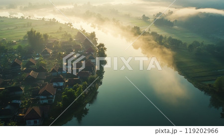 Misty river view with village, foggy morning, serene landscape, aerial shot. 119202966