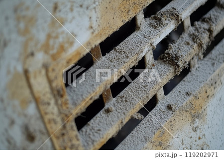 Close-up of a dirty air filter covered in dust and debris, needs cleaning and maintenance. 119202971