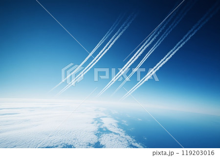 High-altitude sky with contrails of multiple aircraft across a clear blue horizon 119203016
