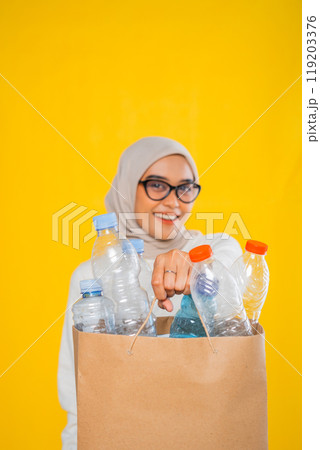 cropped view of hijab woman holding plastic bottle in paper bag cropped view of hijab woman holding plastic bottle in paper bag 119203376