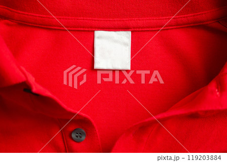 Blank white laundry care clothes label on red shirt fabric texture background Blank white laundry care clothes label on red shirt fabric texture background 119203884
