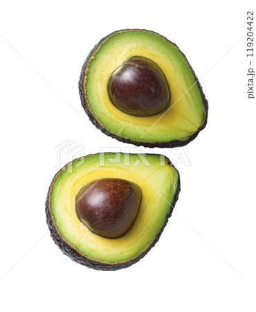 Ripe avocados cut open to reveal creamy interior and seed on a white background 119204422