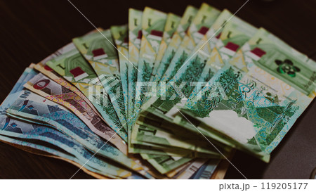 Currencies and money exchange trading concepts. Qatari 500 Riyals Bank Note . Qatari Currency roll Currencies and money exchange trading concepts. Qatari 500 Riyals Bank Note . Qatari Currency roll 119205177