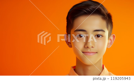 Portrait of a cute handsome happy Asian teenager guy with perfect skin, orange background, banner. Portrait of a cute handsome happy Asian teenager guy with perfect skin, orange background, banner. 119205943