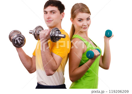 Couple exercising with dumbbells lifting weights 119206209