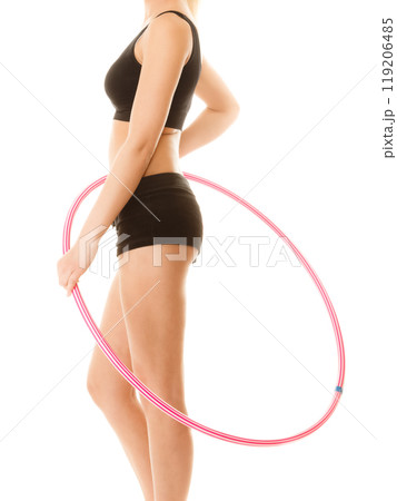 sporty fit girl doing exercise with hula hoop. 119206485