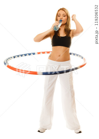 sporty fit girl doing exercise with hula hoop. 119206532
