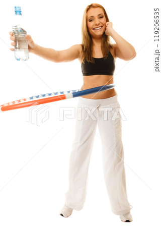 sporty fit girl doing exercise with hula hoop. 119206535