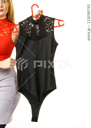 Woman presenting black top jump suit Woman presenting black top jump suit 119206793