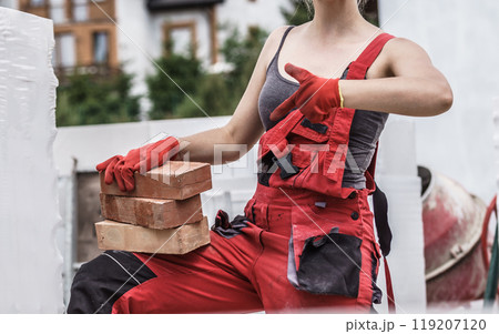 Woman working with bricks 119207120