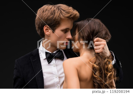 Sexy couple embracing shot on dark background Sexy couple embracing shot on dark background 119208194