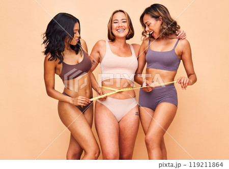 Women group, underwear and measuring tape in studio portrait for laugh, support and diversity by background. Girl friends, healthy body and lingerie for weight loss, helping and cosmetic with pride Women group, underwear and measuring tape in studio portrait for laugh, support and diversity by background. Girl friends, healthy body and lingerie for weight loss, helping and cosmetic with pride 119211864