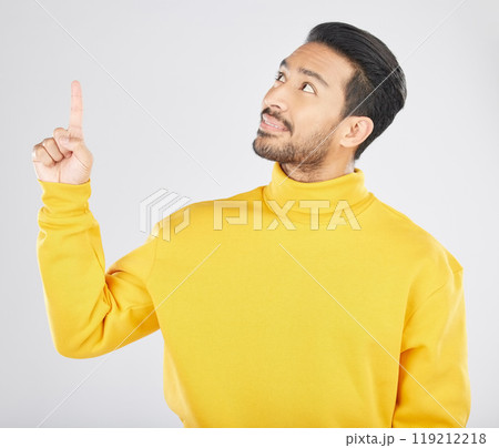 Announcement, thinking and man pointing for promotion, deal and logo isolated in a studio white background with smile. Choice, offer and happy person or ambassador showing advertising or news 119212218