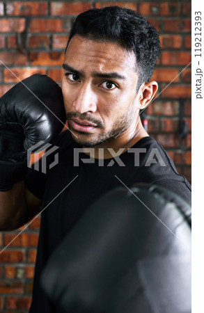 Portrait, man and exercise with boxer athlete, serious and training for combat sport with fighting with gloves. Fist, mma match or workout, energy for performance goal and strong or cardio power Portrait, man and exercise with boxer athlete, serious and training for combat sport with fighting with gloves. Fist, mma match or workout, energy for performance goal and strong or cardio power 119212393