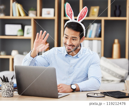 Businessman, bunny ears and video call at home in online meeting with computer screen and wave greeting. Remote work, holiday and rabbit costume for digital education class with male teacher at house Businessman, bunny ears and video call at home in online meeting with computer screen and wave greeting. Remote work, holiday and rabbit costume for digital education class with male teacher at house 119212476