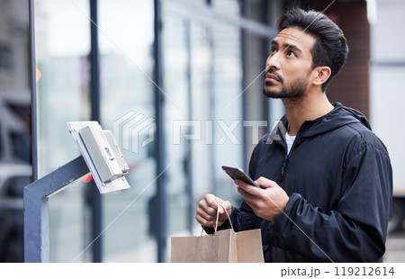 Courier man, paper bag and city with phone, typing and delivery app with search in supply chain job. Young logistics worker, package and thinking with smartphone, product and ecommerce in metro cbd 119212614