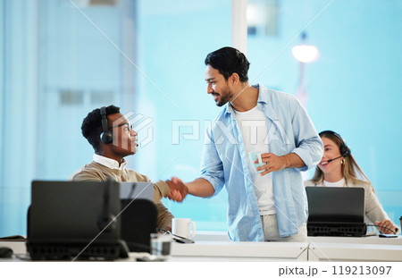 Call centre, man and handshake for teamwork in office for telecom, customer care and services. Diversity, manager and thank you for employee with headset, work and feedback on crm, web or sales 119213097
