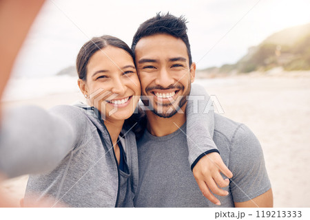 Happy couple, beach and selfie in fitness for photography, memory or outdoor workout together. Portrait of man and woman smile in photograph, picture or social media vlog on ocean coast for exercise Happy couple, beach and selfie in fitness for photography, memory or outdoor workout together. Portrait of man and woman smile in photograph, picture or social media vlog on ocean coast for exercise 119213333