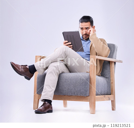 Tablet, concern and a man psychologist in a chair on a white background in studio to listen for diagnosis. Psychology, mental health and reading information with a person counseling during therapy Tablet, concern and a man psychologist in a chair on a white background in studio to listen for diagnosis. Psychology, mental health and reading information with a person counseling during therapy 119213521