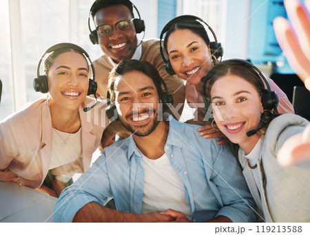 Selfie, call centre and people with headset in office for communication, customer service or telemarketing. Diverse group, man and woman with smile, happy and pose for teamwork, collaboration or bond Selfie, call centre and people with headset in office for communication, customer service or telemarketing. Diverse group, man and woman with smile, happy and pose for teamwork, collaboration or bond 119213588