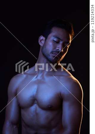 Topless, dark and sexy man on black background in fitness inspiration, beauty aesthetic or strong fantasy. Bodybuilder art, body and seductive male model with muscle, studio and neon blue lighting Topless, dark and sexy man on black background in fitness inspiration, beauty aesthetic or strong fantasy. Bodybuilder art, body and seductive male model with muscle, studio and neon blue lighting 119214334