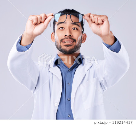 Man, glasses and vision of ophthalmologist at studio isolated on a white background. Frame, spectacles and optometrist, doctor and medical professional with lens, healthcare or wellness of optician 119214417