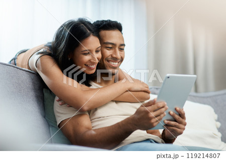 Happy, love and couple hug with tablet on sofa for social media, movies or streaming film at home. Support, smile or people in living room with digital, search or app for show, video or communication 119214807