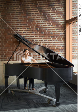 Piano, musician or woman in a house for music training in an artistic classical performance in Japan. Lady pianist, relax and female person playing a song, learning jazz or practice routine in home 119215192