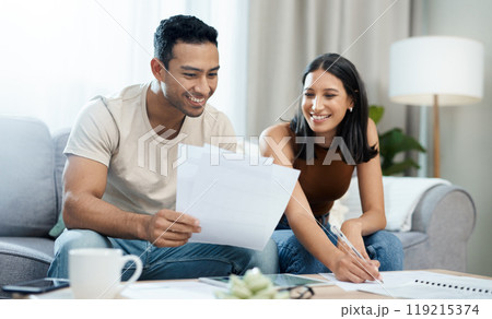 Happy couple, documents and budget planning in finance, expenses or bills together on sofa at home. Man and woman smile with paperwork in living room for loan, financial plan or insurance at house 119215374