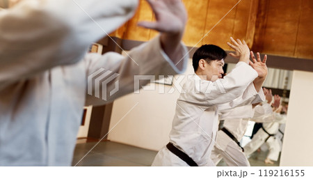 Aikido class, group and people for martial arts, strike or together for combat at training, gym or dojo. Black belt students, fight and exercise for workout, fitness and conflict at Japanese club 119216155