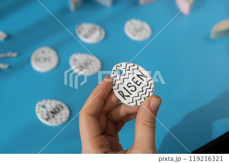 Master class writing word RISEN on EASTER clay egg Unrecognizable artist do it yourself air dry clay crafts for Easter holiday. Decoration gift idea Handmade children craft. Step by step instruction Master class writing word RISEN on EASTER clay egg Unrecognizable artist do it yourself air dry clay crafts for Easter holiday. Decoration gift idea Handmade children craft. Step by step instruction 119216321