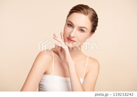 Beautiful young woman with clean fresh skin on beige background, Face care, Facial treatment, Cosmetology, beauty and spa, women portrait. Beautiful young woman with clean fresh skin on beige background, Face care, Facial treatment, Cosmetology, beauty and spa, women portrait. 119218242
