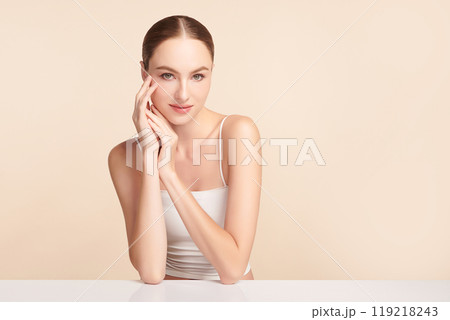 Beautiful young woman with clean fresh skin on beige background, Face care, Facial treatment, Cosmetology, beauty and spa, women portrait. Beautiful young woman with clean fresh skin on beige background, Face care, Facial treatment, Cosmetology, beauty and spa, women portrait. 119218243