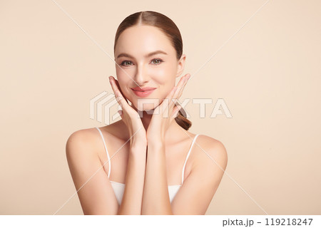 Beautiful young woman with clean fresh skin on beige background, Face care, Facial treatment, Cosmetology, beauty and spa, women portrait. Beautiful young woman with clean fresh skin on beige background, Face care, Facial treatment, Cosmetology, beauty and spa, women portrait. 119218247