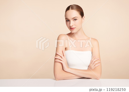 Beautiful young woman with clean fresh skin on beige background, Face care, Facial treatment, Cosmetology, beauty and spa, women portrait. 119218250