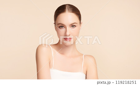 Beautiful young woman with clean fresh skin on beige background, Face care, Facial treatment, Cosmetology, beauty and spa, women portrait. Beautiful young woman with clean fresh skin on beige background, Face care, Facial treatment, Cosmetology, beauty and spa, women portrait. 119218251