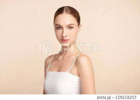Beautiful young woman with clean fresh skin on beige background, Face care, Facial treatment, Cosmetology, beauty and spa, women portrait. 119218257