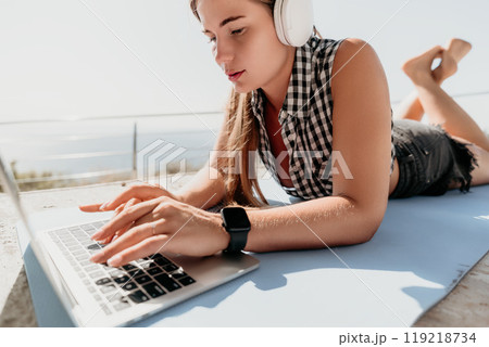 Woman Working on Laptop Outside on a Sunny Day 119218734