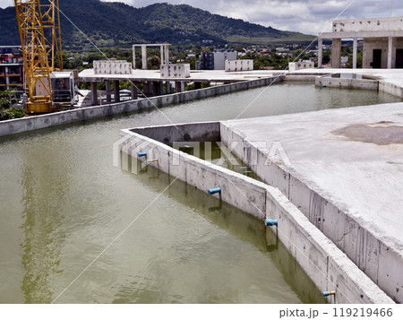 Large building with a roof pool of water under construction Large building with a roof pool of water under construction 119219466