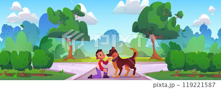 Little kid boy playing with dog in city park. 119221587