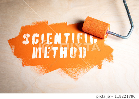 Scientific Method. Orange paint and paint roller on wood texture background 119221796