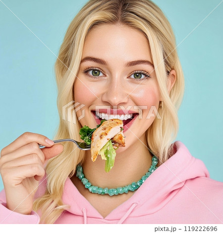 Happy woman smiling and eating a roasted chicken with salad. Photography featuring healthy eating or 119222696