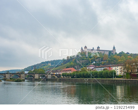 Wuerzburg, Germany - Oktober 19th 2023: View over the Main river towards the historic bridge and the bastion. 119225499