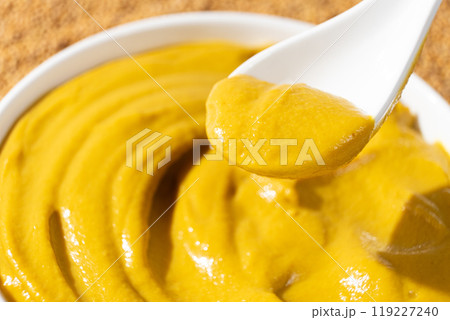 Traditional spicy mustard sauce in a spoon close-up. 119227240